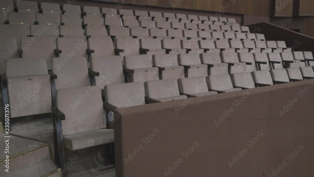 Gray chairs in an empty cinema hall. Empty chairs. The failure of the film at the box office. Concert hall without spectators and fans. The night before the premiere performance. Studio TV show Gray chairs in an empty cinema hall. Empty chairs. The failure of the film at the box office. Concert hall without spectators and fans. The night before the premiere performance. Studio TV show