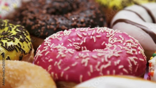 assorted donuts with different fillings and icing. Dolly video