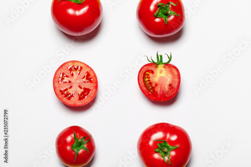 Top view of bunch of fresh tomatoes isolated on white background © NewFabrika