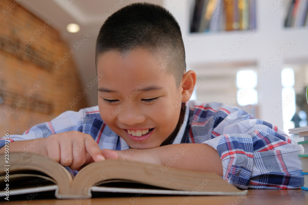 little asian kid boy child children studying reading book. little asian kid boy child children studying reading book.