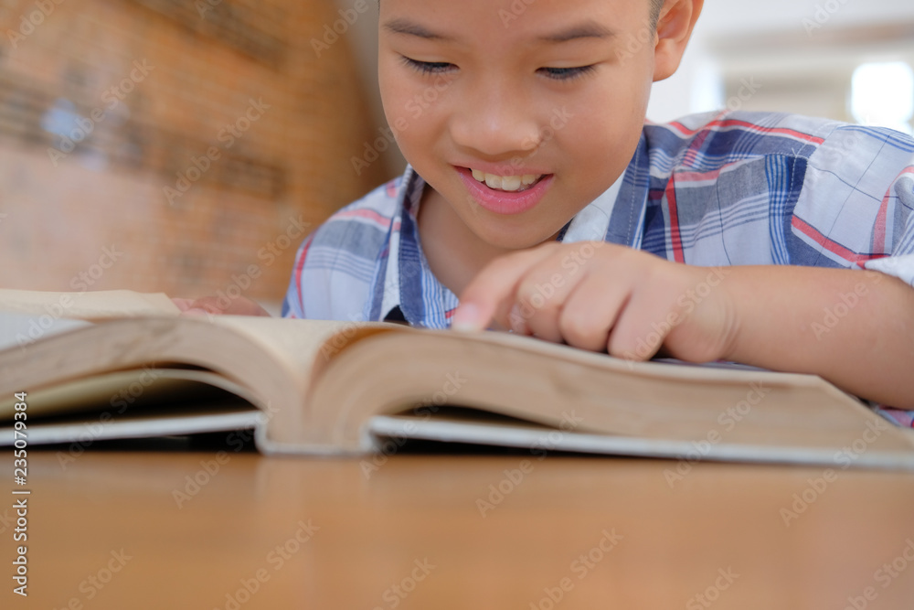 little asian kid boy child children studying reading book. little asian kid boy child children studying reading book.
