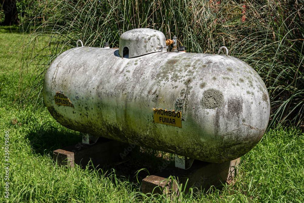 Old and moldy rusty white industrial propane gas tank Old and moldy rusty white industrial propane gas tank