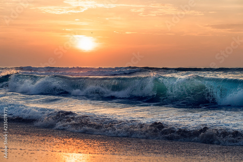 Sunset over the sea  big waves and colorful sky