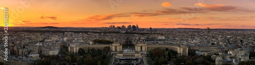 Aerial: Place du Trocadero on the background of the skyscrapers in Paris, sunset, panoramic image © castenoid