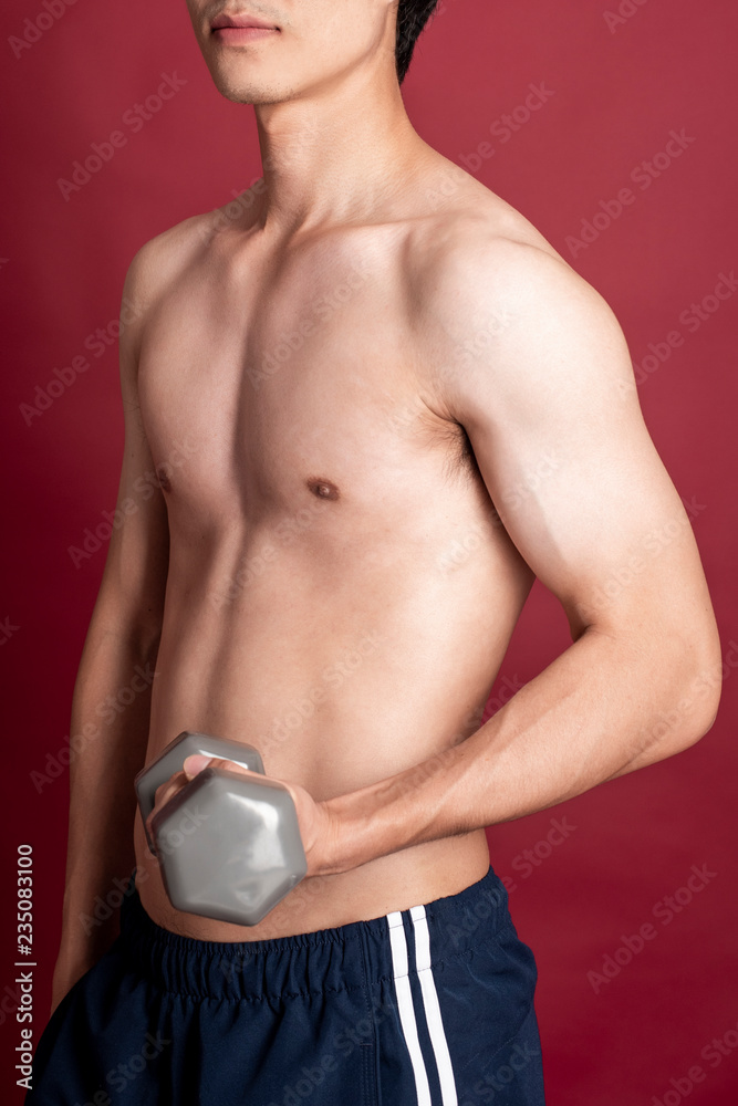 Naklejka premium Fitness man on red background