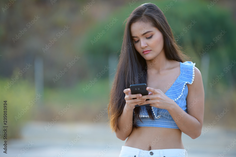 Young Beautiful Asian Tourist Woman Using Phone
