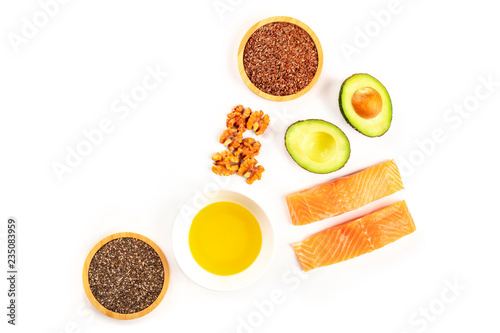 Healthy omega-3 diet food ingredients. Raw salmon, avocado, nuts, chia seeds, flaxseeds, shot from above on a white background with copy space