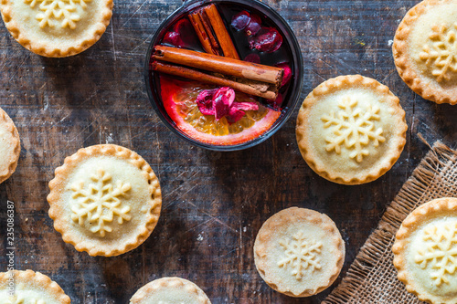 Traditional Christmas mince pies and mulled wine on wooden table - top view photo