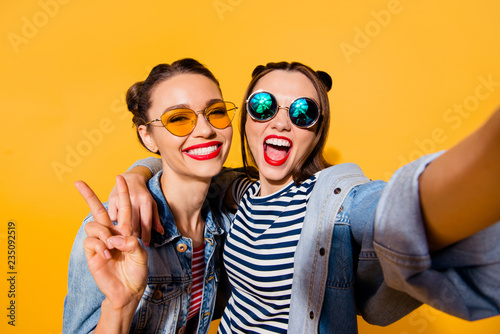 Two glad positive grinning lady stand in glasses spectacles stre