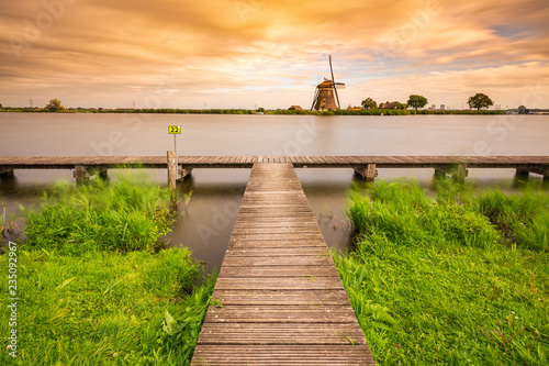 Old Dutch traditional windmill located at Rottemeren during sunset photo