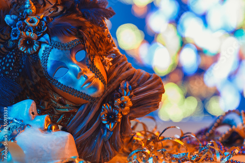 Traditional female carnival venetian mask on blue bokeh background. Masquerade  Venice  Mardi Gras  Brazil festival concept