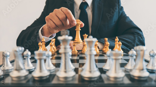 Businessman leadership playing chess and thinking strategy plan about crash overthrow the opposite team and development analyze for successful of corporate