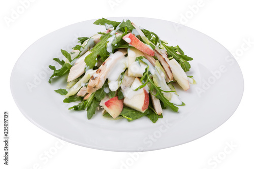 fitness salad of chicken, arugula and apple slices, with white sauce, on a plate, isolate