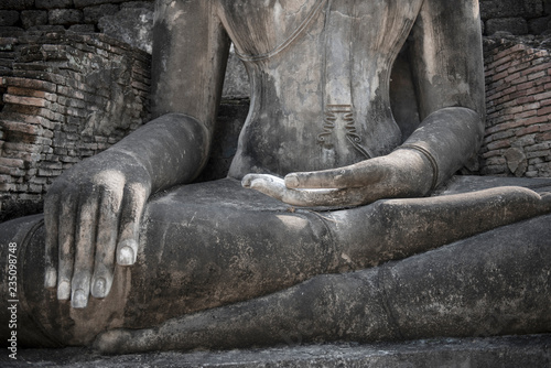 buddha meditation, the ruin Buddha statue on the old brick wall photo