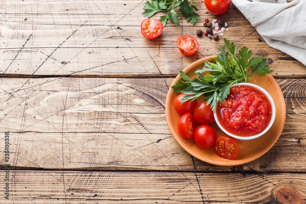 Tomato sauce pasta in a bowl and fresh tomatoes with parsley on a wooden table Copy space Tomato sauce pasta in a bowl and fresh tomatoes with parsley on a wooden table Copy space
