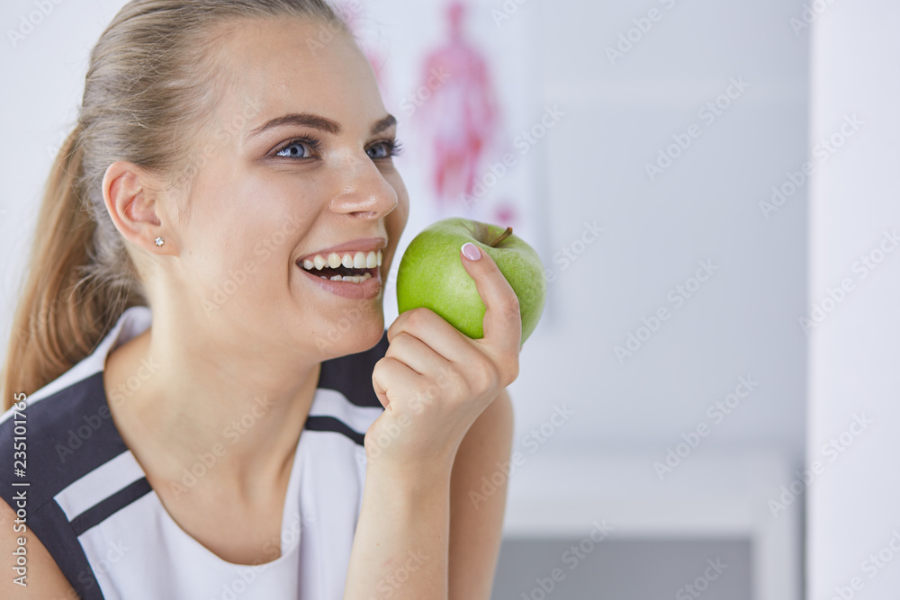 Young beautiful smiling girl with a green apple in hands Young beautiful smiling girl with a green apple in hands