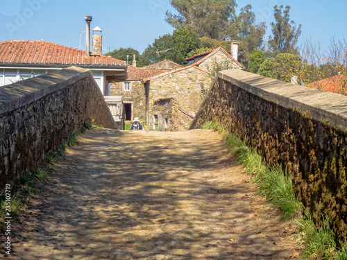 Medieval bridge over the Furelos River - Furelos, Galicia, Spain photo