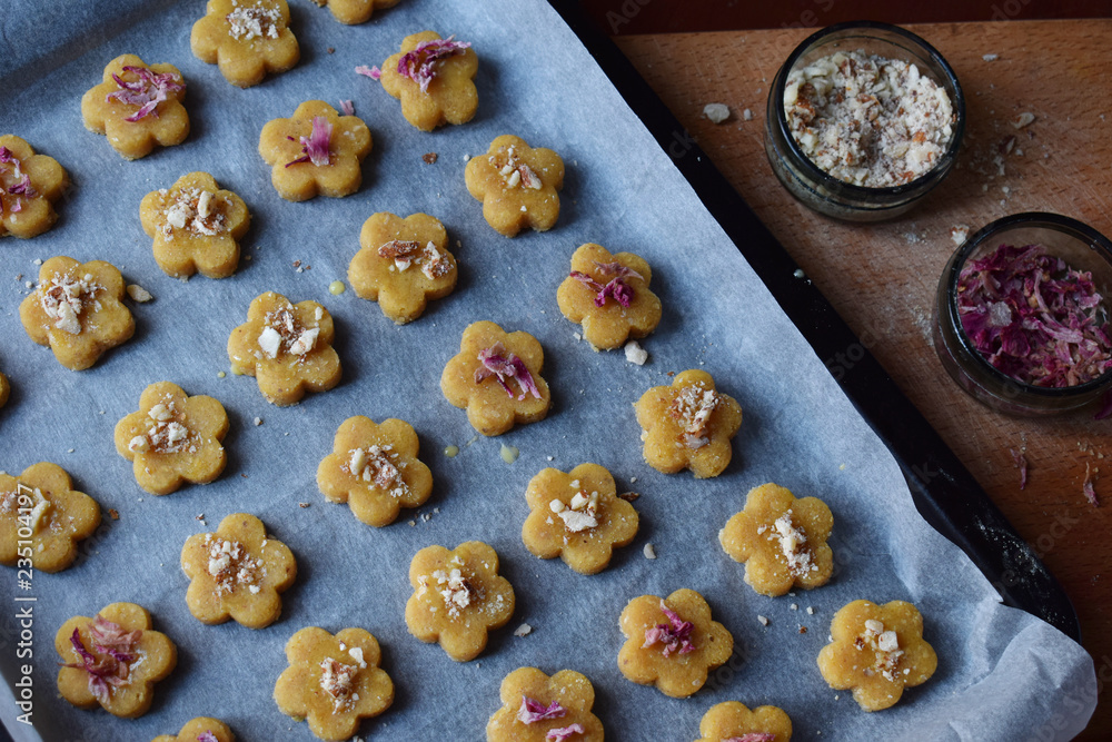 Making chickpea cookies pastries with almonds and tea rose petals. Traditional Eastern sweets. Gluten free. Grain free. Paleo diet. Healthy food. Step 4. Sprinkle cookies with nuts and rose petals. Making chickpea cookies pastries with almonds and tea rose petals. Traditional Eastern sweets. Gluten free. Grain free. Paleo diet. Healthy food. Step 4. Sprinkle cookies with nuts and rose petals.