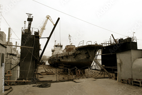 Archive 2008 River port of Ust-Danube was destroyed in of crisis. Old rusty boats on stocks in dry dock of river port. Old river vessels rust on dock repair shop stocks for repair of river vessels © Aleksandr Lesik