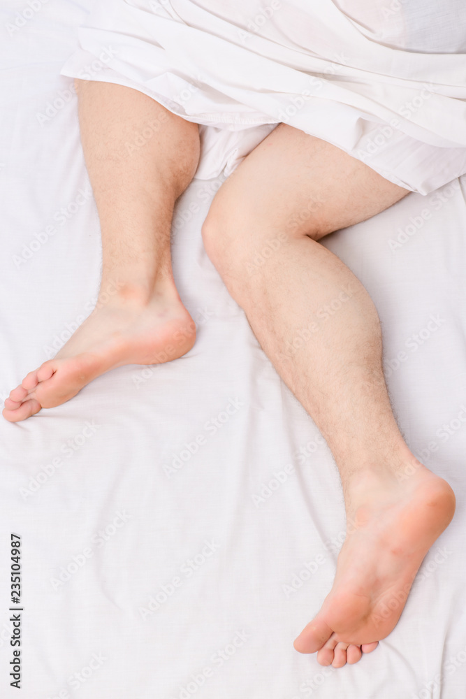 Cheerful young man is waking up after sleeping in the morning. Man eyes are closed with relaxation. The routine. Cheerful young man is waking up after sleeping in the morning. Man eyes are closed with relaxation. The routine.