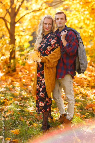 Image of embracing couple on walk in autumn forest