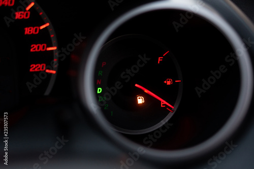 The car dashboard shows the flue gas with red. The oil warning light is running out.Close up image of illuminated car dashboard