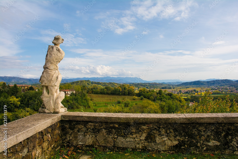 The autumn landscape in the Collio vineyard area of Friuli Venezia Giulia, north west Italy, showing a statue from the historic Abbazia di Rosazzo Abbey
