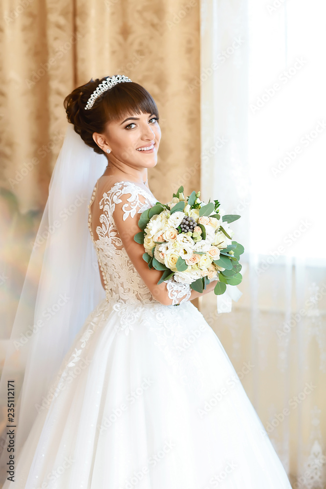 Bridal bouquet. Wedding. Woman in a white dress holds a beautiful bouquet of white flowers and greenery Bridal bouquet. Wedding. Woman in a white dress holds a beautiful bouquet of white flowers and greenery