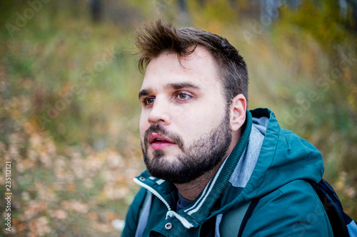 handsome male tourist hiking in the forest