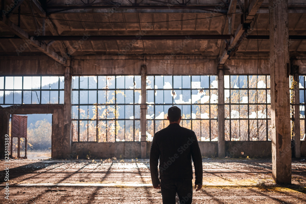 Handsome Man walk thru the Empty Factory