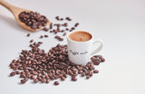Turkish coffee and coffee beans close up and wooden spoon background. White background.