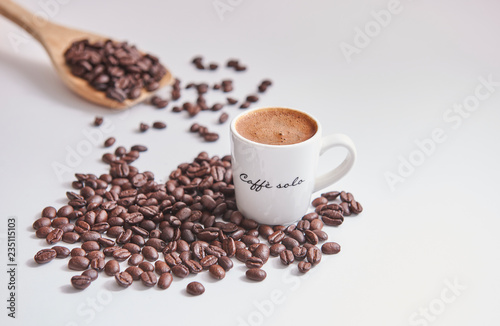 Turkish coffee and coffee beans close up and wooden spoon background. White background.