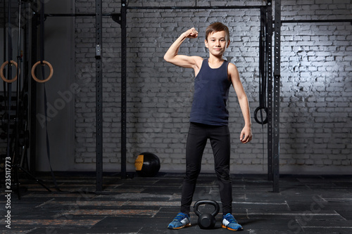 Training and sport. Kid in crossfit gym. Healthy lifestyle.
