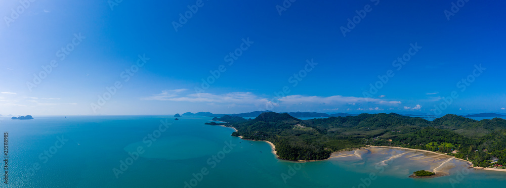 Aerial panoramic view of a beautiful green tropical island with bays and sandy beaches