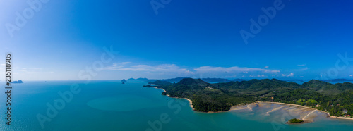 Aerial panoramic view of a beautiful green tropical island with bays and sandy beaches