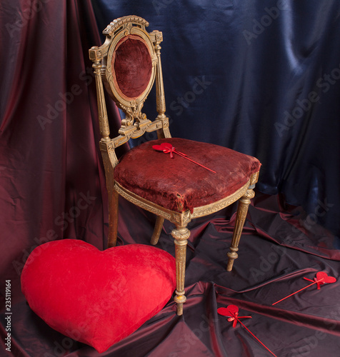 a large red heart and small hearts, an antique chair. Valentine's Day.