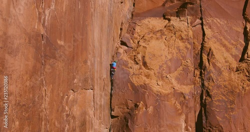 Wallpaper Mural Aerial view of man rock climbing extreme route reaching for hand hold Torontodigital.ca