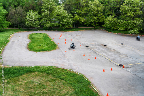 Man is practicing driving a motorcycle in a driving school