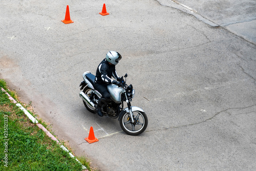 Man is practicing driving a motorcycle in a driving school photo