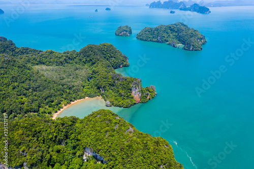 Aerial drone view of beautiful lush green tropical islands with remote, empty bays and beaches