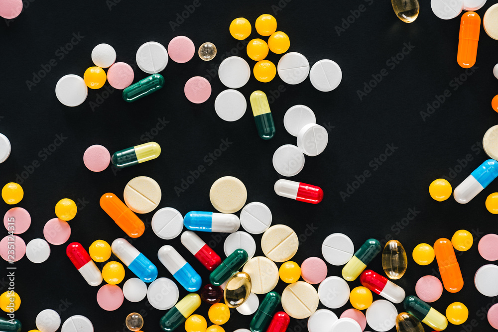 view from of pile colorful various pills isolated on black view from of pile colorful various pills isolated on black