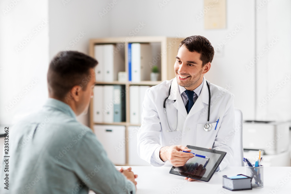 medicine, healthcare and technology concept - doctor with tablet pc computer and male patient talking at medical office in hospital medicine, healthcare and technology concept - doctor with tablet pc computer and male patient talking at medical office in hospital