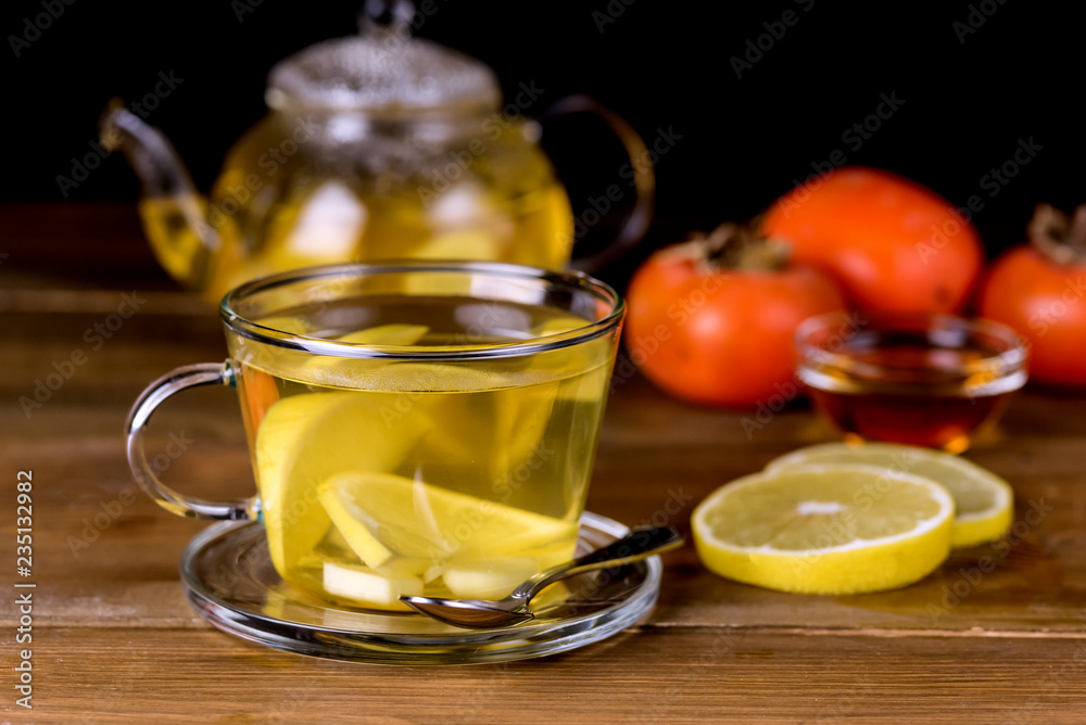 Glass Cup and Glass Teapot with Hot and Tasty Lemon and Ginger Tea Hot Autum Winter Drink Close Up Glass Cup and Glass Teapot with Hot and Tasty Lemon and Ginger Tea Hot Autum Winter Drink Close Up