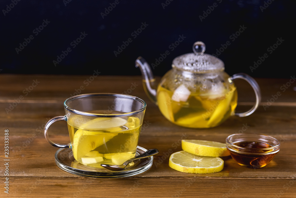 Glass Cup and Glass Teapot with Hot and Tasty Lemon and Ginger Tea Hot Autum Winter Drink Close Up