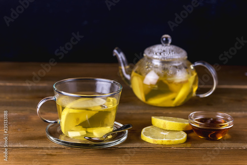 Glass Cup and Glass Teapot with Hot and Tasty Lemon and Ginger Tea Hot Autum Winter Drink Close Up