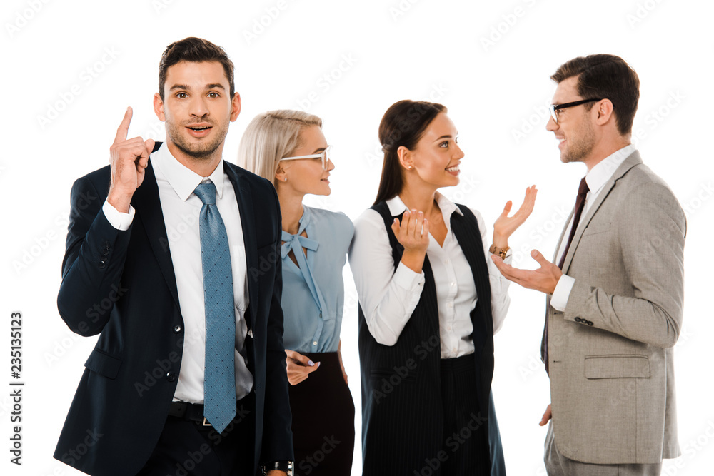 successful businessman having idea and pointing up while colleagues discussing behind isolated on white successful businessman having idea and pointing up while colleagues discussing behind isolated on white