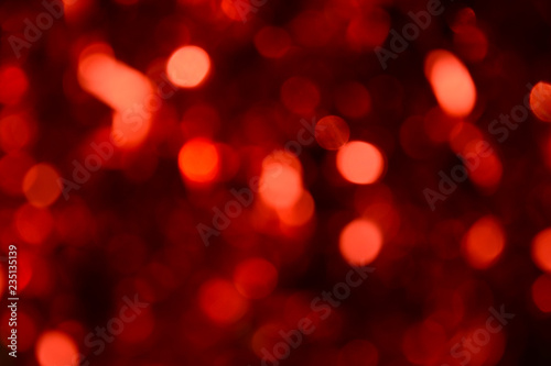 Bokeh. Holiday background. Christmas lights. Glitter. Defocused sparkles. New Year backdrop. Festive wallpaper. Blinks. Carnival. Bokeh retro style photo. Red.