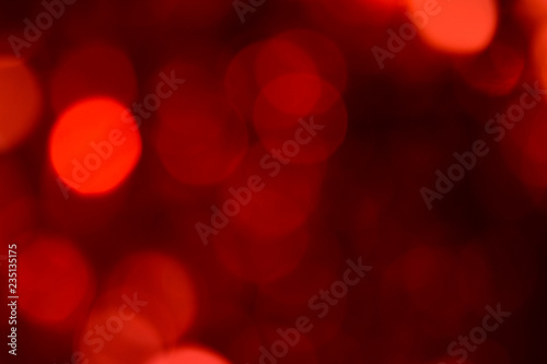 Bokeh. Holiday background. Christmas lights. Glitter. Defocused sparkles. New Year backdrop. Festive wallpaper. Blinks. Carnival. Bokeh retro style photo. Red.