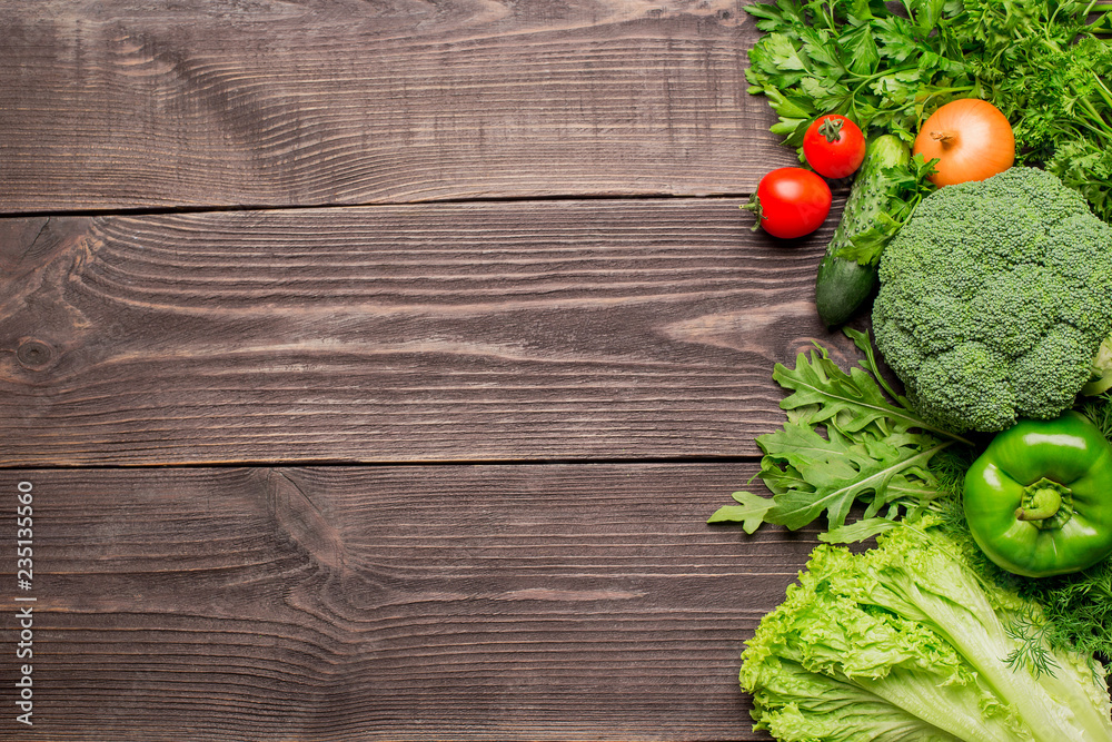 Frame of green and red fresh vegetables on wooden background, top view Frame of green and red fresh vegetables on wooden background, top view