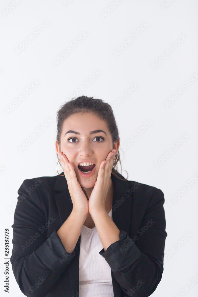 Portrait of surprised Caucasian girl pressing hands to cheeks and shouting. Young female manager reacting to unexpected good news with open mouth. Astonishment concept Portrait of surprised Caucasian girl pressing hands to cheeks and shouting. Young female manager reacting to unexpected good news with open mouth. Astonishment concept
